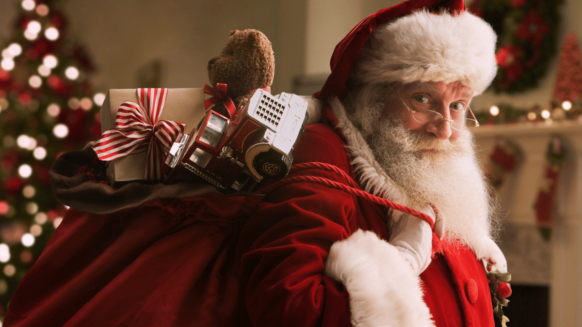 Père Noël en rouge portant un sac